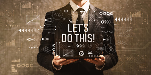 Let's do this with businessman holding a tablet computer on a dark vintage background
