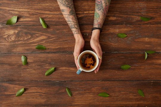 Female hands with hot tea