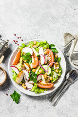 Chicken,garbanzo beans, tomato salad. Top view, space for text.