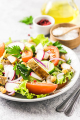 Grilled chicken tomato chickpeas salad with olive oil mustard vinaigrette. Selective focus, space for text.