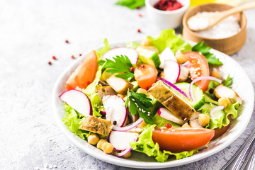 Grilled chicken tomato chickpeas salad with olive oil mustard vinaigrette. Selective focus, space for text.