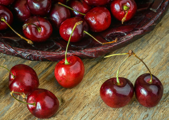 Ripe red sweet cherries on wood background, close up.