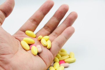 Colorful pills and medicines in the hand
