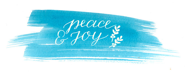 Holiday card with inscription Peace and joy, made hand lettering on blue watercolor background