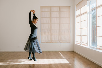Young professional dancer practicing in a studio