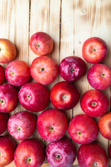 heap of unwashed unclean red apples mix on wooden background, top side view closeup