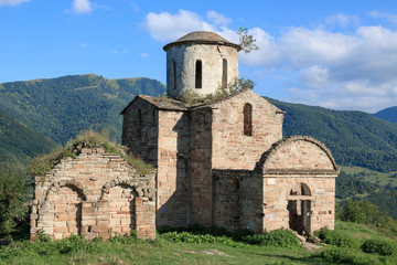 Fototapeta na wymiar Old church in mountains, in national park Dombai, Caucasus, Russia