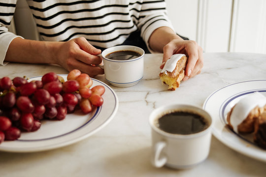 Breakfast with coffee, eclairs and grapes