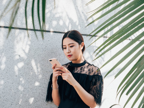 Asian young woman using cell phone