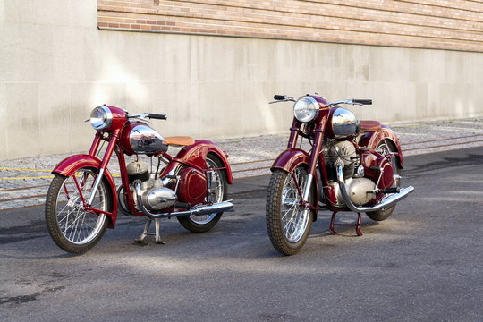 Red vintage motorcycles Jawa 125 and Jawa 500 produced in former Czechoslovakia stand on road