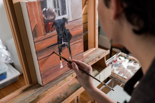 Woman painting from a dog photo