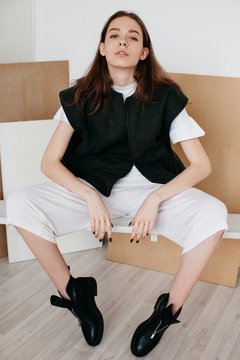 Fashionable young girl posing indoors and looking at camera