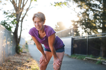 Healthy mature woman on urban morning run