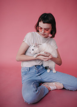 Woman stroking cat in studio