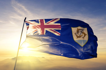 Anguilla Anguillian flag textile cloth fabric waving on the top sunrise mist fog