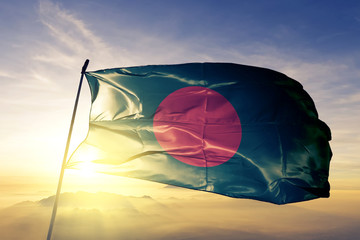 Bangladesh Bangladeshi flag textile cloth fabric waving on the top sunrise mist fog