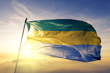 Gabon Gabonese Gabonaise flag textile cloth fabric waving on the top sunrise mist fog