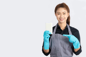 Beautiful Attractive Asian Maid smile and holding sponge for cleaning feeling so happiness and confident,Isolated on grey background,Maid Cleaning Service Concept