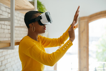 Woman wearing virtual reality headset at office.