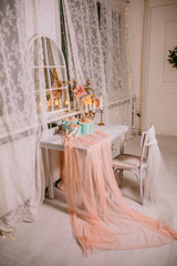 Christmas holiday composition a group of gifts on table on the background of garlands and fireplace. New year 2019. Place for text.