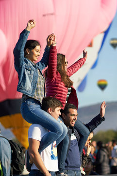 Group Of Friends Having A Happy Time At A Hot Air Balloon Festival