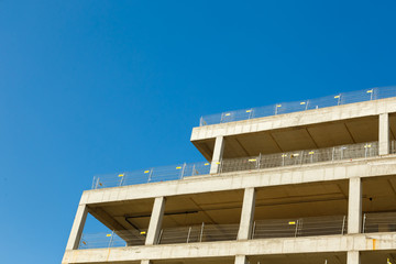 Unfinished building an apartment house on a background of blue sky