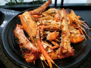 food scraps in the buffet restaurant. Close up of dirty dishes and seafood waste after eating.