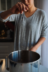 A young girl cooks in her kitchen