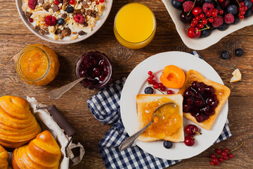 Breakfast. Toasts with cherry or peach jam and fresh fruit.
