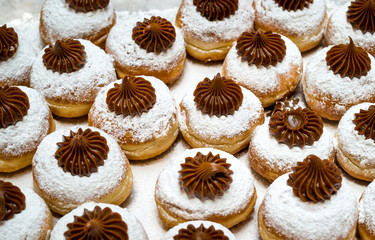Fresh  chocolate donuts at bakery display for Hanukkah celebration. Selective focus.