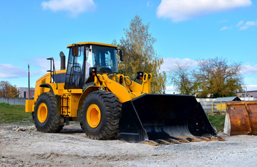 Wheel loader on a construction site. Diesel bulldozer with bucket