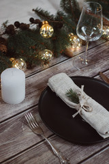 Wooden Table with Christmas decorations and garland, ware, green spruce branches