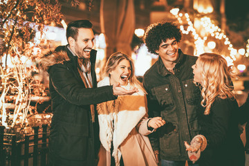 Friends Having Fun Outdoors In Winter City