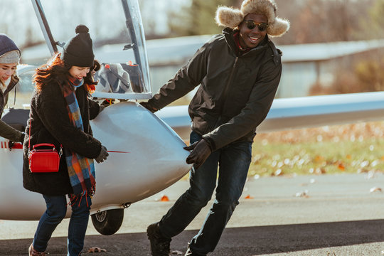 Friends pulling glider from the runway after flight