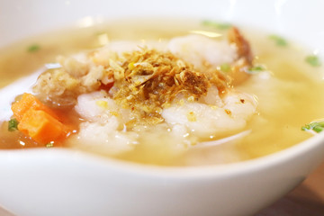 Shrimp porridge on wooden background.