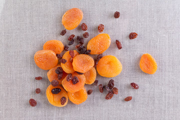 Dried apricots and raisins on rustic background. Healthy food concept. Top view