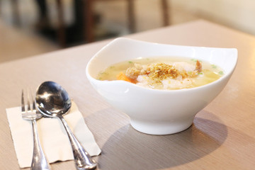 Shrimp porridge on wooden background.