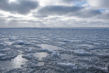 Ice freezes in winter on the surface of a large body of water.
