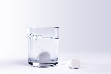 Closeup of a glass of water with effervescent tablets
