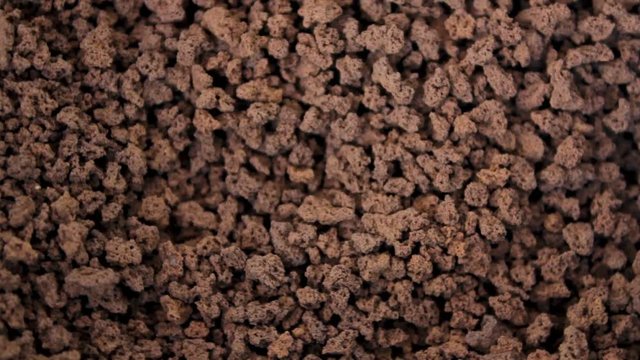 Macro view of Instant granulated coffee. Top view and Video rotation
