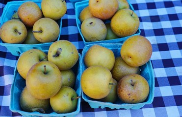 Naklejka na ściany i meble Baskets of Asian pears (Pyrus pyrifolia) at the farmers market in the fall