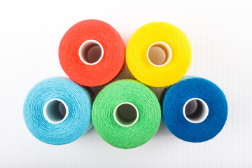 Red, yellow, blue and green thread spools