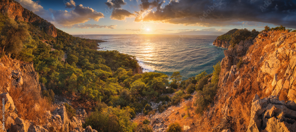 Wall mural sunset over the mediterranean sea bay