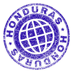 HONDURAS stamp print with distress texture. Blue vector rubber seal print of HONDURAS caption with unclean texture. Seal has words arranged by circle and globe symbol.