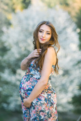 Fototapeta premium young pregnant woman in national park