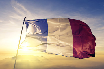 France French flag textile cloth fabric waving on the top sunrise mist fog