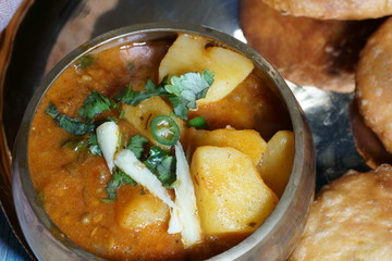 Spicy and tangy Aalu or potato sabji or curry served with Khasta
