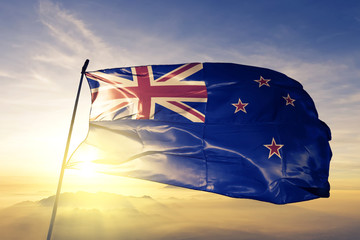 New Zealand Zealander flag textile cloth fabric waving on the top sunrise mist fog