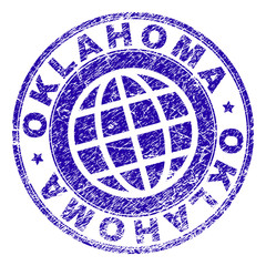 OKLAHOMA stamp imprint with grunge texture. Blue vector rubber seal imprint of OKLAHOMA caption with grunge texture. Seal has words arranged by circle and planet symbol.