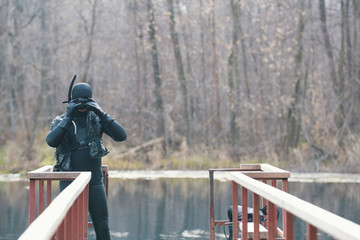 Fisherman in wetsuit and mask in preparation for a hunt. Autumn forest lake